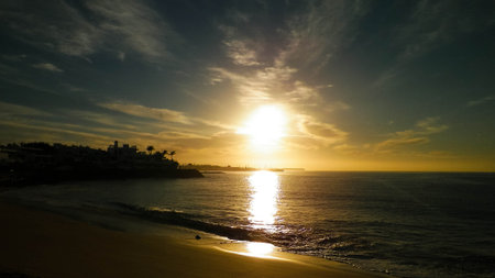 Beautiful nature background of sunset over beach in Playa Blanca, Lanzarote, Canarian Islands. Sunlight and Atlantic ocean. Vacations, tourism and nature concept.の写真素材