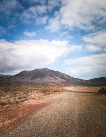 Desert and mountains is a typical scenery of the island of Lanzarote. Canary Islands archipelago.の写真素材