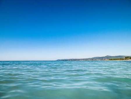 Sea coast in Vada, Tuscany, Italy. Mediterranean nature in summer day, blue, Tyrrhenian sea water on blue sky background. Vacations and nature concept. Copy space.の写真素材
