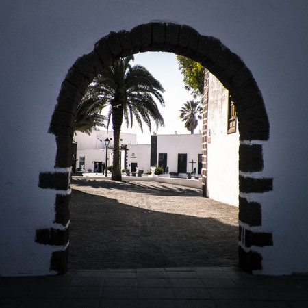 Architectural column and street view of Yaiza City, Lanzarote is. Canarian architecture and exotic nature.の写真素材