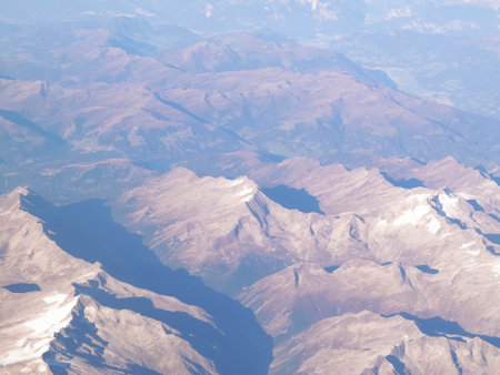 Alps, view of the mountains from the window of the plane. Land bending and nature concept.の写真素材