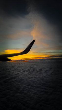 Plane travel at sunrise or sunset. Beauty of nature view from plane window.