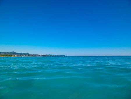 Sea coast in Vada, Tuscany, Italy. Mediterranean nature in summer day, blue, Tyrrhenian sea water on blue sky background. Vacations and nature concept. Copy space.の写真素材