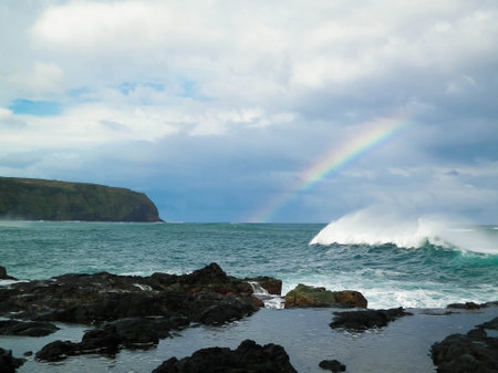 Rainbow over the Atlantic Ocean. Sao Miguel island coast. Azores.