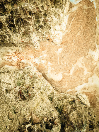 Coastal rocks and sea water as a natural background. Copy space.