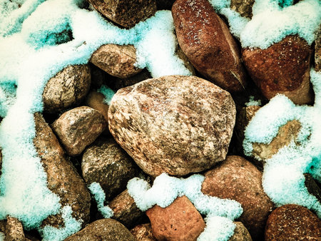 Snow on stones as nature background.の写真素材