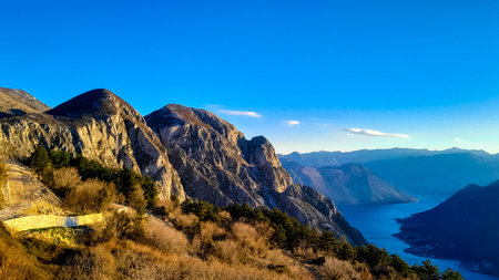 Sunny day over Lovocen Mountain tops and Kotor Bay fjords. The Lovcen Mountains lie around Boka Kotorska in Montenegro. Kotorska bay in a foreground.の写真素材