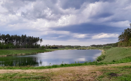Moody sky over Lake Borowiec in Kashubia. Incoming rain.の写真素材