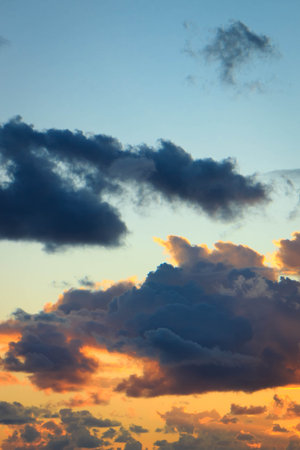Amazing sunset or sunrise sky. Clouds in light of sun. Stunning view.の写真素材