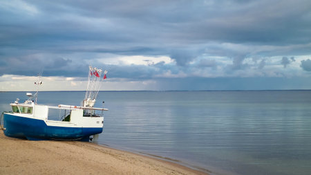 Fishing boat on a Baltic Sea coast in Mechelinki, Poland. Mechelinki is a small fisherman's village in Poland. Copy space on cloudy sky.の写真素材