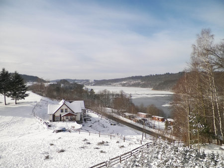 Mountain house on the coast of Ostrzyckie Lake in winter. Wiezyca Poland.の写真素材