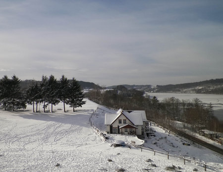 Mountain house on the coast of Ostrzyckie Lake in winter. Wiezyca Poland.の写真素材