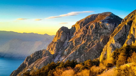 Lovcen mountain peaks on a sunny day. The Lovcen Mountains lie around Boka Kotorska in Montenegro. Kotorska bay in a foreground.の写真素材