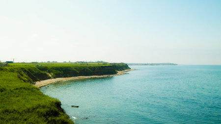Green grass on cliffs on the Black Sea coast. Landscape of cliffs and beach in Vama Veche, Dobrogea region, Romagna. Nature and traveling concept.の写真素材