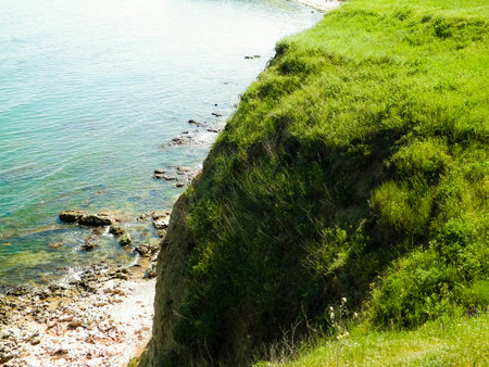 Green grass on cliffs on the Black Sea coast. Landscape of cliffs and beach in Vama Veche, Dobrogea region, Romagna. Nature and traveling concept.の写真素材