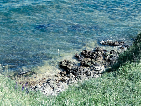 View from cliff on water of Black Sea. Beautiful transparent water of Black Sea, exploration and nature concept, Romania, Dobrogea region.の写真素材