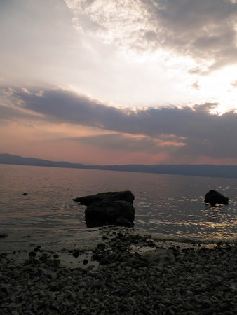 Sunset over Ohrid lake. Reflection of the sun in the beautiful water of Lake Ohrid. Beauty in nature...
