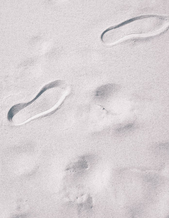 Travelers footstep on beach or desert. Natural background.