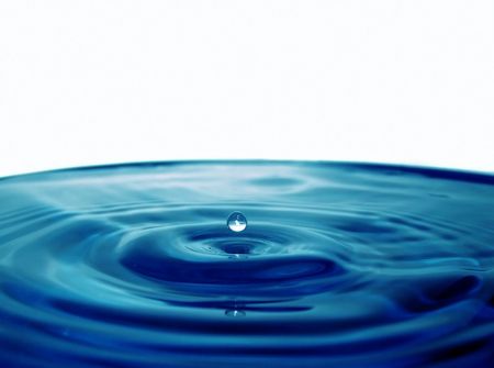 Droplet falling in blue waterの写真素材