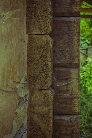 Outward ancient wooden blockhouse wall fragment with corner wall junction.の写真素材