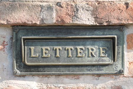 Old letterbox at a historic facadeの写真素材