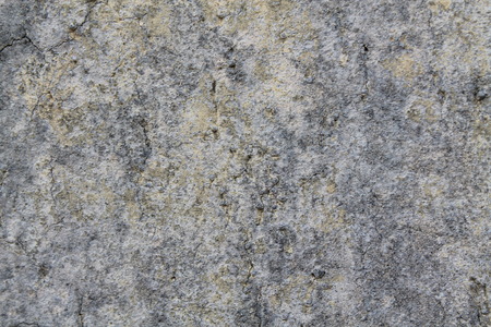 Granite rock closeup background, stone texture, cracked surfaceの写真素材