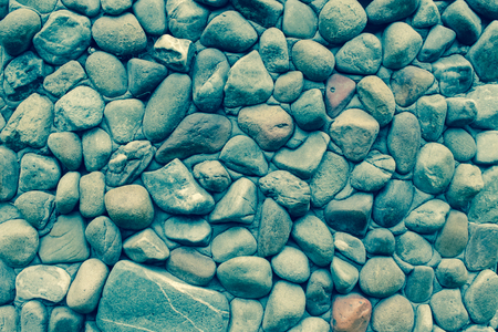 Wall stones. Yellow and brown pebblesの写真素材