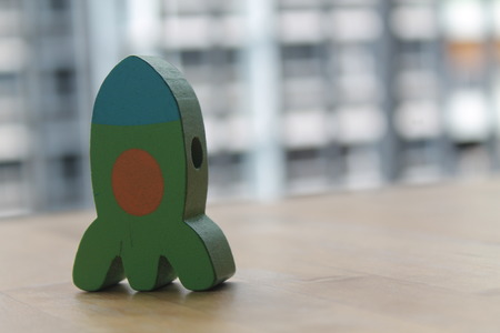 Christmas toy for Christmas tree isolated on the white background with the shadow. Green wooden rocket.の写真素材