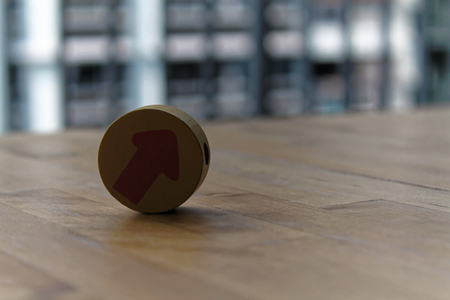 Wooden toy arrow on the circle on the table.の写真素材