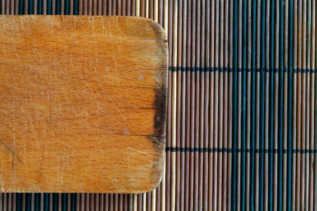 Vintage empty cutting board on bamboo planks, food background conceptの写真素材
