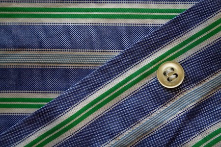 Part of blue - green striped shirt with buttons texture or background