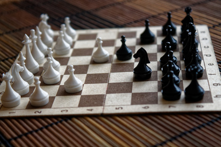 Wooden Chess Board and steel chess pieces, isolated on boardの写真素材