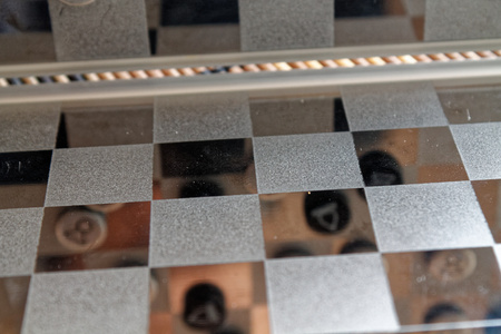 Photo with a picture of a chess steel Board and chess pieces, Metal chess pieces on a chess Board...
