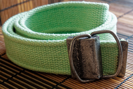 Fashion green Belt isolated on wooden backgroundの写真素材