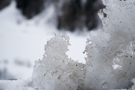 Snow Winter background, close-up of frosted ice lump on a snowing day with copy space.
