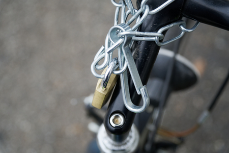 Padlock bicycle lock Close-up lock with security chain attached.の写真素材