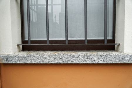 Old dirty window on old cement rough wall.の写真素材