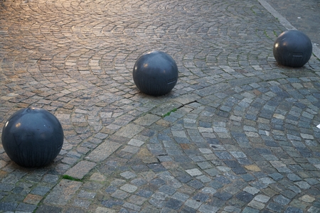 Cobblestone street pavement on a square with round decorative stone in the evening.の写真素材