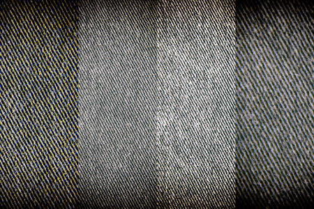 Detailed closeup of blank grungy denim. Vintage dark gray jeans, good for backgroundの写真素材