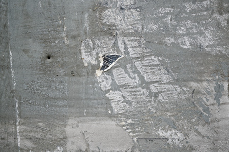 Torn poster after vote on tin textured wall Ripped newspaper