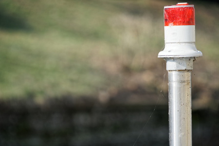 Electric signal lantern on the river water canal, beacon for the boats.の写真素材