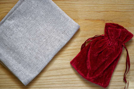 Postcard sample, grenadine gift pouch on wooden background with free copyspace for greeting text.の写真素材