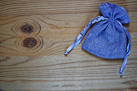 Postcard sample, blueberry gift pouch on wooden background with free copyspace for greeting text.の写真素材