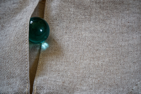 Crystal on linen fabric surface, mock-up for postcard or background for website and mobile devices. Gem colored inの写真素材