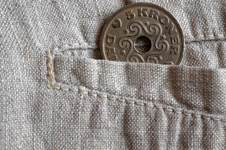 Denmark coin denomination is five krone (crown) in the pocket of worn linen pants