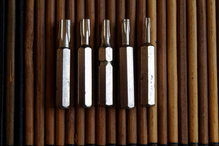 Head for screwdriver (bits) on wooden background, Tools collection turn-screw