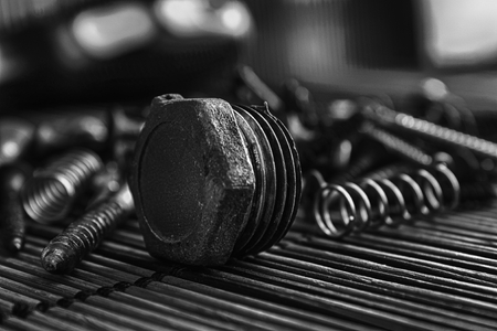 Monochrome scattered Screws and bolt isolated on wooden background Texture for web site ot mobile...