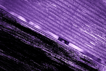 Grunge Ultra purple Texture of old, shabby, green paint on an old wooden bench with hole.の写真素材