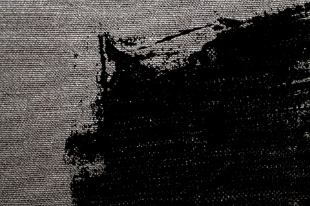 Spotted Detailed closeup of blank grungy denim. Vintage gray jeans, good for background.