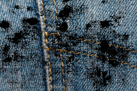 Dirty grunge Closeup of obsolete blue jeans pocket Denim texture, macro background for web site or mobile devices.の写真素材